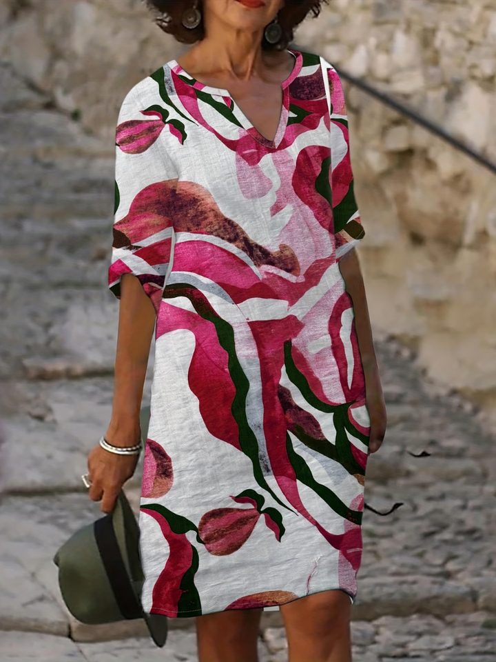 Close-up of abstract warm-tone print fabric on Susan dress