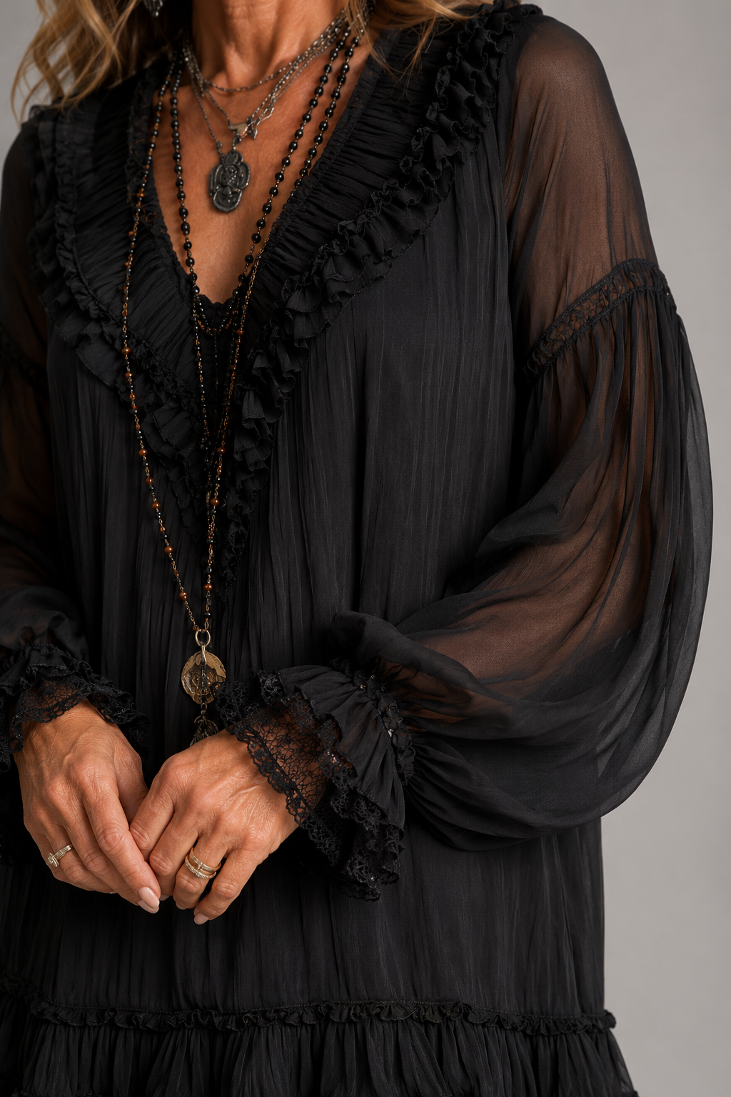 Close-up of the ruffled hem and long sleeves on the Nadine dress