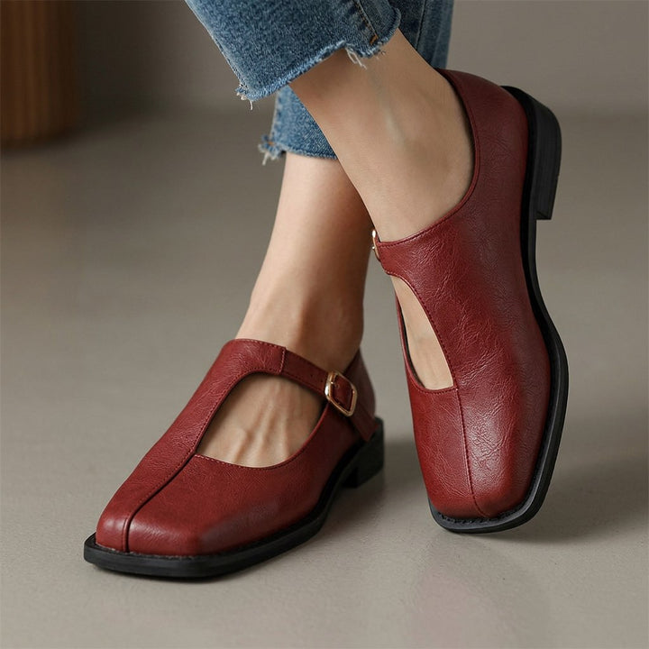 Rosalie Mary Janes in red, side view showing the adjustable ankle strap and low heel